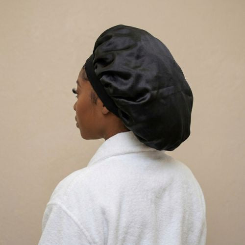Model wearing a black hair bonnet