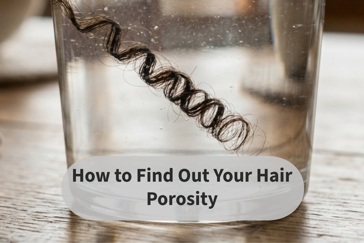 How to find your hair porosity, a strand of hair in a cup