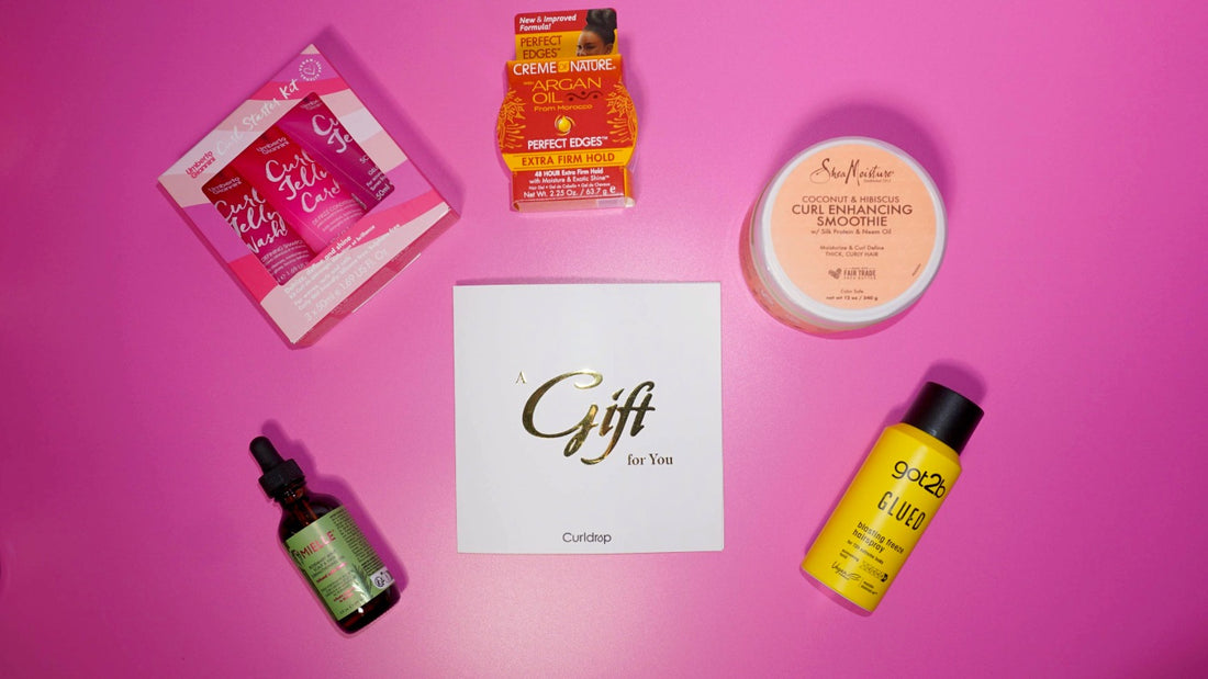 Collection of hair care products on a pink background