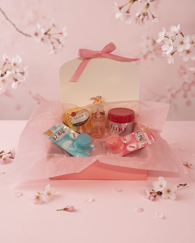 Set of japanese hair products on a pink background with cherry blossoms